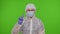 Doctor in PPE protective suit disapproving showing warning rejecting dangerous no sign on chroma key