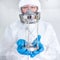 Doctor in PPE suit holding hourglass