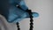 Doctor prays to God, doctor`s hand in gloves and rosary