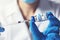 Doctor preparing covid-19 vaccine dose for vaccination. closeup of syringe and vial in hands