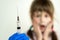 Doctor preparing vaccination injection with a syringe to an afraid child girl. Vaccination of children at school concept