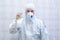 Doctor in protective suit with antiseptic spray in hands
