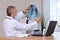 A doctor in a protective surgical mask examines the X-ray of the lungs in his office. Lungs, coronavirus, pneumonia treatment