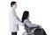 Doctor pushing wheelchair with disabled patient