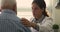 Doctor put hand on older patient shoulder providing psychological support