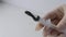 Doctor puts the leech into syringe forr hirudotherapy procedure