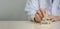 Doctor putting and stacking wooden block cube icon symbol medical health care on table panorama background concept