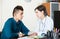 Doctor receiving and questioning teen patient at office