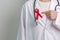 Doctor with Red Ribbon for December World Aids Day, acquired immune deficiency syndrome, multiple myeloma Cancer Awareness month