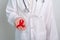 Doctor with Red Ribbon for December World Aids Day, acquired immune deficiency syndrome, multiple myeloma Cancer Awareness month