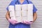 Doctor with rolls of toilet paper in his hands. A nurse holds a lot of rolls of white toilet paper, diarrhea concept