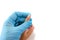 The doctor`s hand in a blue glove holds a child`s hand with a sore finger. A wart or papilloma on a child`s finger. White backgrou