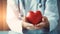 a doctor\\\'s hand delicately holding a red heart shape, AI-Generated