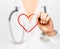 Doctor\'s hand drawing a heart symbol.