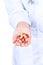 Doctor\'s hand holding many yellow tablets