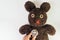 Doctor`s hand holding stethoscope put on cute brown handmade fluffy doll with pitty eyes, healthcare for children or kids, medica