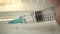 Doctor`s hand holds a syringe and a vaccine bottle at the hospital. Health and medical concepts. Covid epidemic. macro
