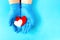 Doctor\\\'s hands in medical gloves hold hearts