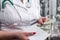 Doctor`s hands putting money into envelope, bribe