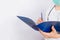 Doctor`s hands in a white coat hold a folder and fill out a medical document close-up isolated on a white background.