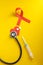 Doctor `s workplace with stethoscope, blister tablets, syringe on yellow background