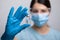 Doctor scientis in protective gloves and mask holding glass vial with injection liquid. Vaccination against influenza and