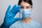 Doctor scientis in protective gloves and mask holding glass vial with injection liquid. Vaccination against influenza and