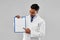 Doctor or scientist with white paper on clipboard