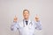 Doctor senior man, medical professional pointing up side with finger isolated over grey background