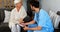 Doctor and senior woman discussing over clipboard