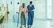 Doctor, senior woman and walking stick for physiotherapy support, healthcare service or physical therapy