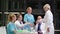 Doctor shaking hands and interacting with colleagues in conference room