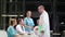 Doctor shaking hands and interacting with colleagues in conference room