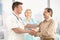 Doctor shaking hands with senior patient