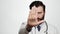 Doctor show STOP, NO. Serious displeased man doctor on white background looking at camera and shows his palm STOP