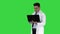 Doctor showing results in laptop on a Green Screen, Chroma Key.