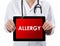Doctor showing tablet with ALLERGY text