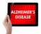 Doctor showing tablet with ALZHEIMERS DISEASE text.