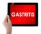 Doctor showing tablet with GASTRITIS text.