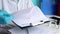 doctor signing covid 19 document medical form close up