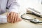 Doctor sitting at desk A stethoscope and examination equipment are placed on the side.