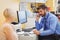 Doctor sitting at his desk and talking on phone