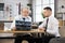 Doctor sitting with patient at desk and holding x ray scan