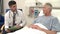 Doctor Sitting By Senior Male Patient\'s Bed In Hospital