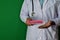 Doctor standing on Green background. Hold the Dementia paper text. Medical and healthcare concept