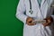 Doctor standing on Green background. Hold the Health Care Reform paper text.