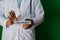 Doctor standing on Green background. Selective focus in hand. High Colesterol paper text. Medical and healthcare concept
