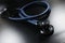 Doctor stethoscope equipment on dark surface, tool for patient diagnostic