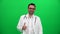 Doctor with Stethoscope Gesturing OK on Green Screen. Good, Approval, Agreement Concept.