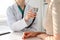 Doctor with a stethoscope in the hand. Physician examines her female patient.